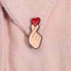 sg-11134201-7qvf3-lfw68m5y1h1d7c.webp Cute Finger Heart Enamel Bagpack Pin